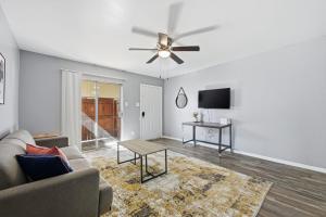 a living room with a couch and a ceiling fan at 2-bedroom with large living area in Denton
