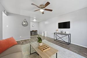 a living room with a couch and a flat screen tv at Denton pad with 2BR comfort in Denton