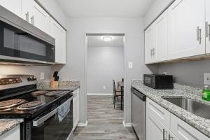 a kitchen with white cabinets and a stove top oven at 2-bedroom with large living area in Denton