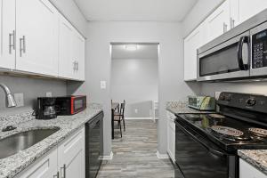 a kitchen with a sink and a stove top oven at Denton pad with 2BR comfort in Denton