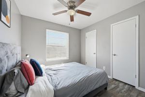 a bedroom with a bed and a ceiling fan at Denton pad with 2BR comfort in Denton +12 photos