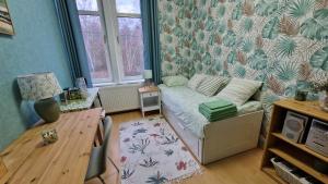 a bedroom with a bed and a desk and a table at Le Nichoir de la Biesme in Aiseau