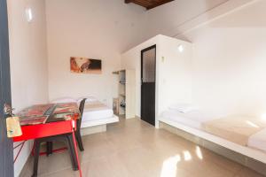 a bedroom with a red desk and a bed at Hotel Casa Encanto in Doradal +30 photos