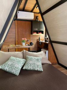 a bed with two pillows on it in a room at Mini Cabana in Serra do Cipo