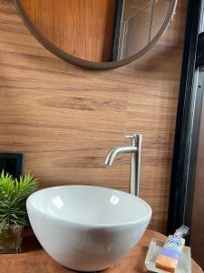 a white bowl sink on a counter in a bathroom at Mini Cabana in Serra do Cipo