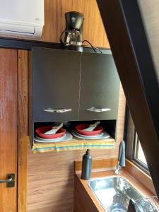 a kitchen with a sink and a counter with plates at Mini Cabana in Serra do Cipo +15 photos