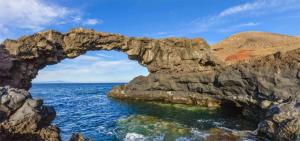 an arch in the rocks near the ocean at La Novelera in Echedo