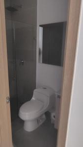 a bathroom with a white toilet and a mirror at Salguero sunset resort apartmento in Gaira +7 photos