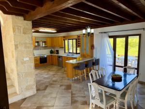 a kitchen with a table and chairs in a room at Villa Grand Zeus in Anoyira