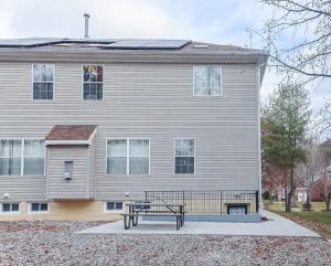 a house with a bench in front of it at Stylish Studio Escape - Calm & Convenient Lanham in Lanham