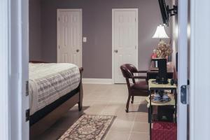 a bedroom with a bed and a desk and a chair at Stylish Studio Escape - Calm & Convenient Lanham in Lanham