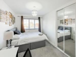 a bedroom with a bed and a mirror at Modern spacious Home in Rhyl in Rhyl