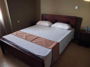 a bed with two pillows on it in a bedroom at Pasikuda Shalom Echo Villa in Palayadithona +95 photos