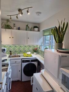 a kitchen with white cabinets and a dishwasher at 4 Bancroft place in Stratford-upon-Avon