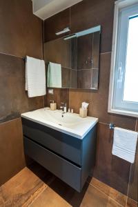 a bathroom with a sink and a mirror at B&B Arcolobello ApartHotel in Corato +38 photos