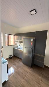 a kitchen with a stainless steel refrigerator in it at Casa privativa Próximo a Itaipu in Foz do Iguaçu +16 photos