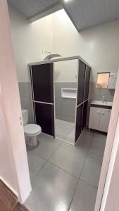 a bathroom with a toilet and a sink at Casa privativa Próximo a Itaipu in Foz do Iguaçu