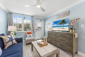 a living room with a couch and a tv at Clearwater Beach Suites #201 in Clearwater Beach