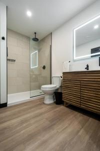 a bathroom with a toilet and a glass shower at Bridge View at The MillRows Suites in New Glasgow +8 photos