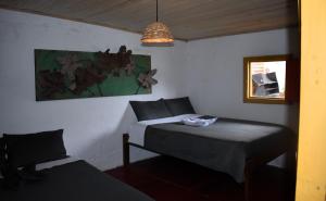 a bedroom with two beds and a chair in it at El Hostal del Abuelo in Murillo