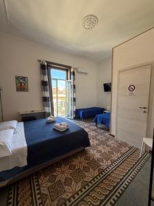 a bedroom with a bed and a door with a window at GUEST HOUSE BOSCO in Palermo