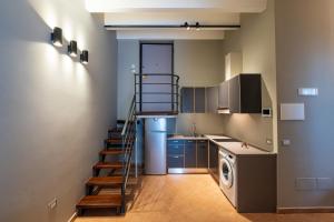 a kitchen with a staircase leading to a laundry room at B&B Arcolobello ApartHotel in Corato