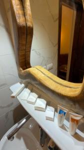 a mirror on top of a sink in a bathroom at King Sahure Pyramid Inn in Cairo +92 photos