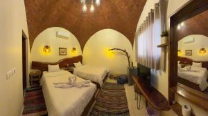 a bedroom with two beds in a room with arches at King Sahure Pyramid Inn in Cairo