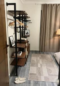 a room with a shelf with shoes on the floor at Sun capital stylish apartment in ‘Ezbet `Abd el-Ḥamîd