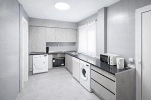 a kitchen with a washer and dryer in it at VUT Casa Trujillano in Ávila