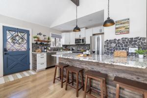 a kitchen with a large counter with a blue door at Pine Cone Cabin Flagstaff 3BR 2BA in Flagstaff