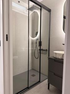 a bathroom with a glass shower with a sink at Apartamento Las Cruces in Plasencia +12 photos