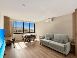 a living room with a couch and a table at Ocean Breeze Rooms, Albufeira in Albufeira