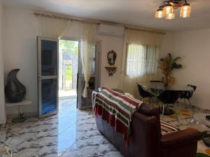 a living room with a couch and a table at Villa Golden Gâte 8 Bred room in Dombé