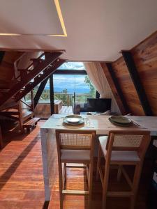 a dining room with a table and chairs with a view at Nature Senses Chapadinha in Cavalcante