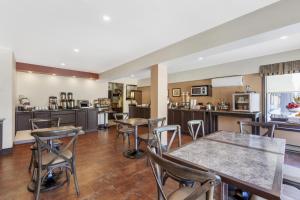 a kitchen and dining room with tables and chairs at Best Western Plus Otonabee Inn in Peterborough