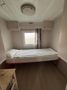 a small bed in a room with a window at Blue Sea Horizon in Wenduine +16 photos