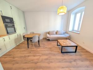 a living room with a couch and a table at Apartament Podgórze Wałbrzych in Wałbrzych