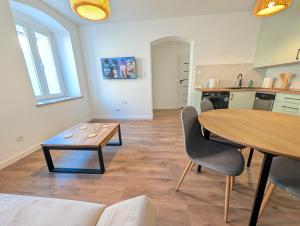 a kitchen and dining room with a table and chairs at Apartament Podgórze Wałbrzych in Wałbrzych