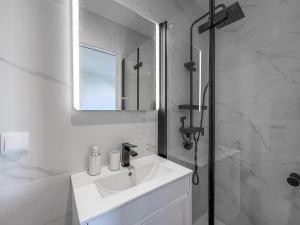 a white bathroom with a sink and a shower at Ocean Breeze Rooms, Albufeira in Albufeira +43 photos