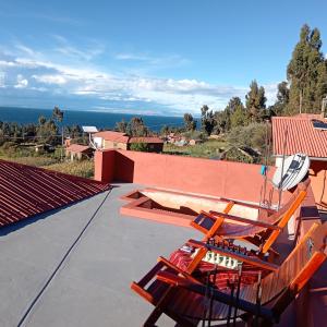 a chair on the roof of a house at Casa Amadeus in Estanciasuyo