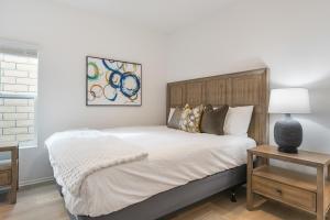 a bedroom with a bed and a table with a lamp at Summerwell by AvantStay in La Quinta +116 photos