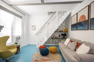 a living room with a couch and stairs at Church GTX in Galveston
