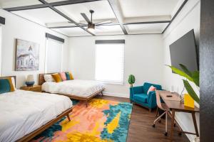 a bedroom with a bed and a desk and a chair at Church GTX in Galveston