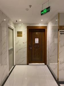 a door in a building with a sign on it at فندق منازل قباء الفندقية in Medina