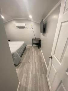 a bedroom with a bed next to a door at Beautiful independent suite in Brandon