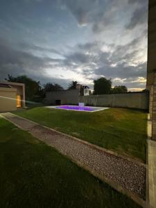 a garden with purple flowers in the grass at Kusi 51 in La Banda