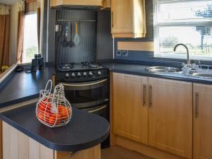 a kitchen with a counter with an orange basket on it at Sea View in Trimingham