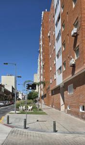 an empty street in front of a brick building at Frente al mar in Montevideo