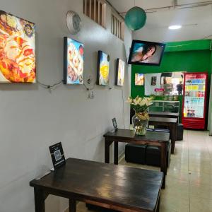a dining room with two tables and a counter with a table sidx sidx at Hotel BSJ Neiva in Neiva